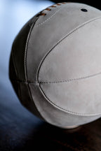 Close-up of stitched panel seams and taupe nubuck texture on the Run Boy leather basketball